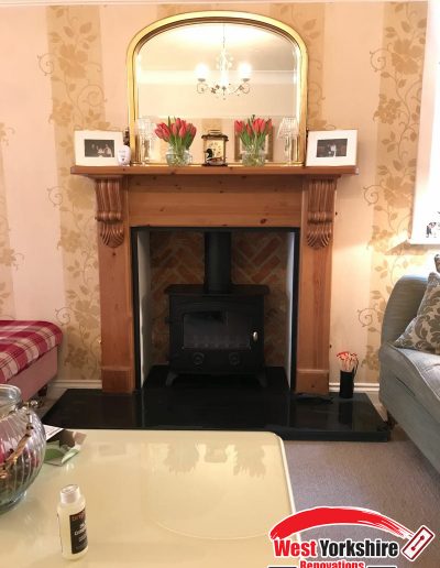 A stove installed into an existing fireplace